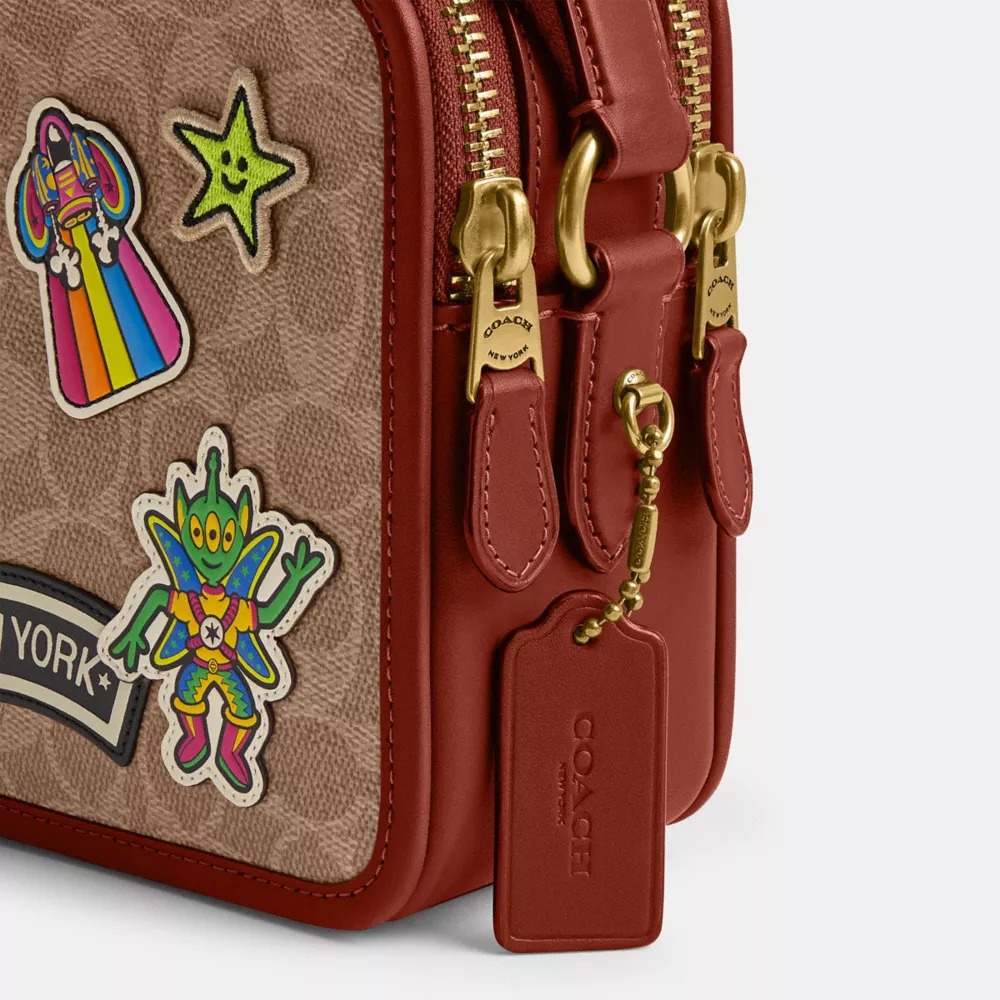 COSMIC COACH CHARTER CROSSBODY 24 IN SIGNATURE CANVAS WITH PATCHES