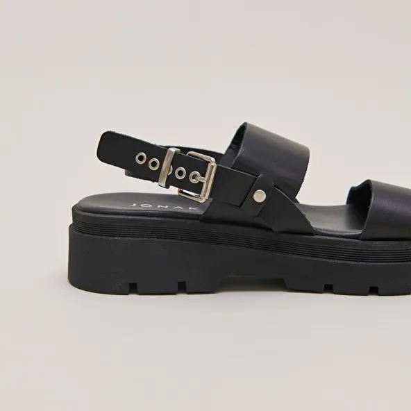 Sandals with thick straps and notched soles in black leather